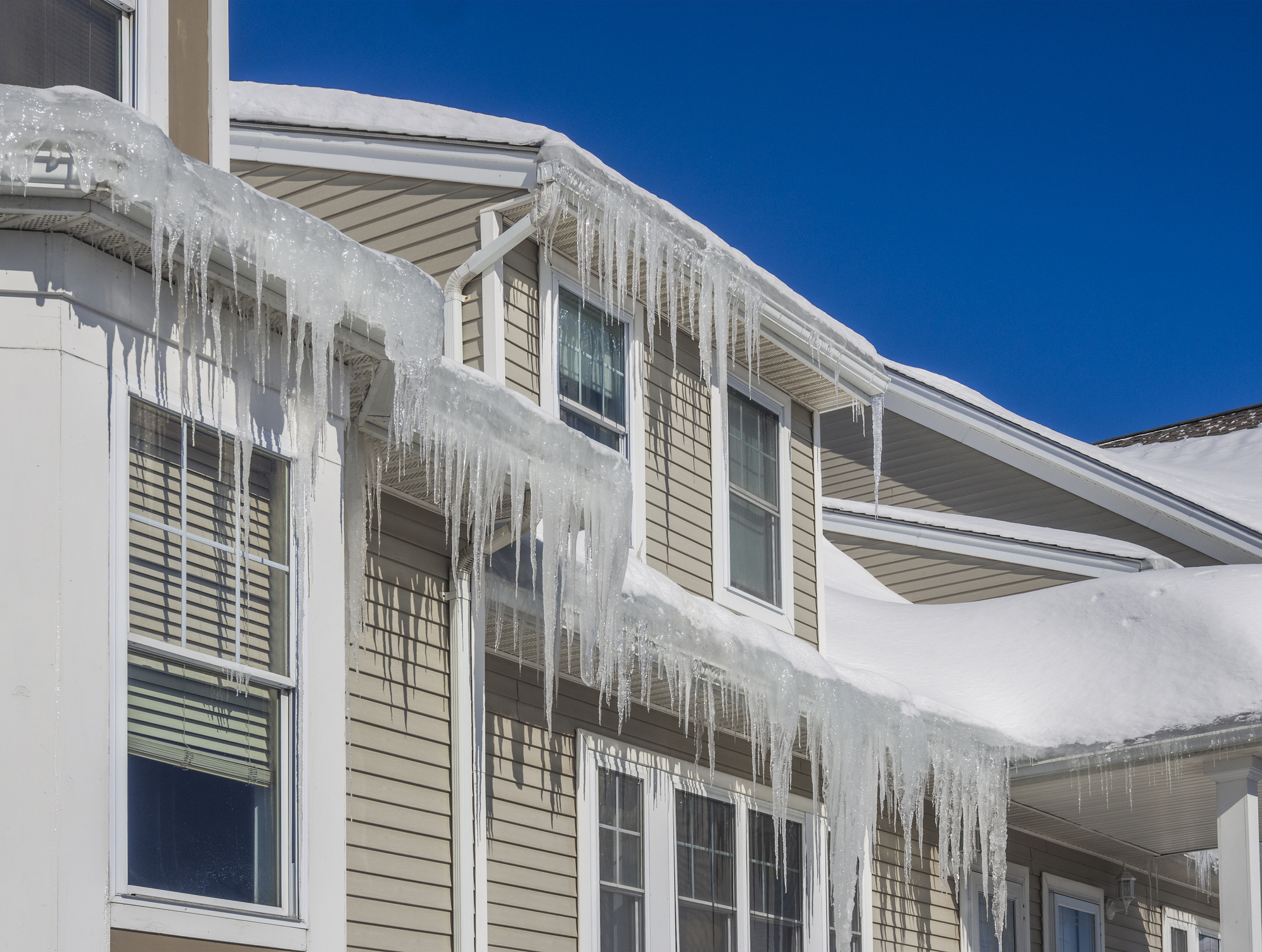 Ice dam and snow on home