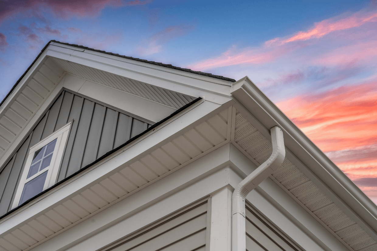 Below gutter view of home with sunset in the background