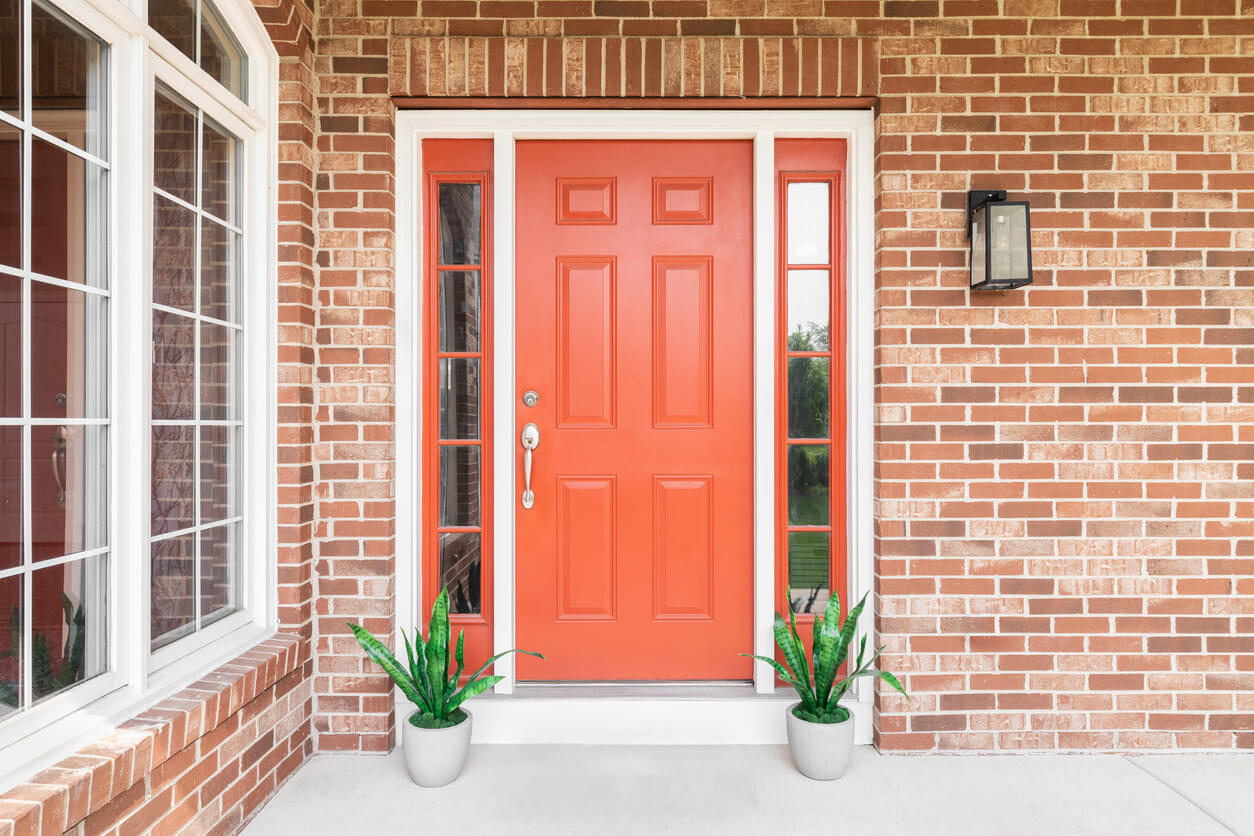 Red front door with matching framed windows.
