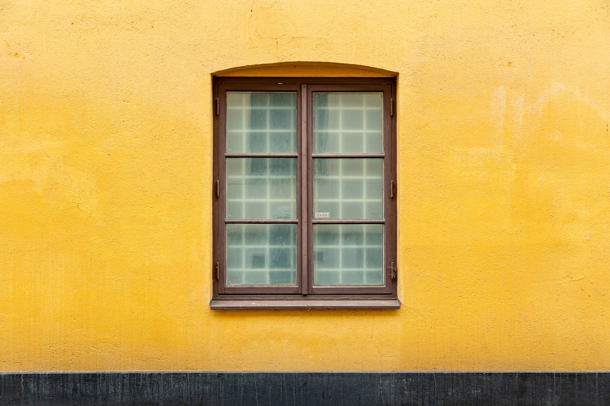 double casement window on yellow house
