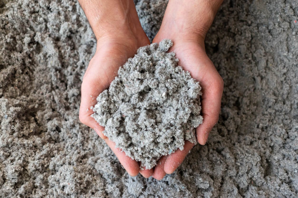 environmentally friendly cellulose insulation in someones hands