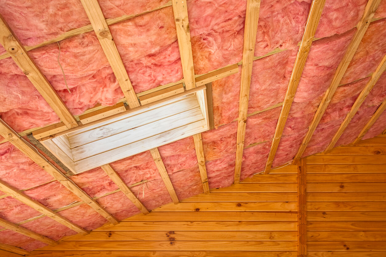 pink blanket insulation installed in an attic ceiling