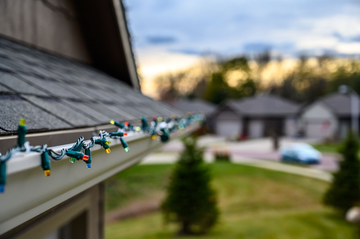 up close image of colored lights lining the gutter on a roof