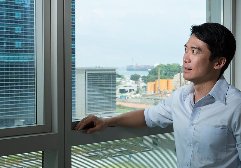 man looking out window after window replacement