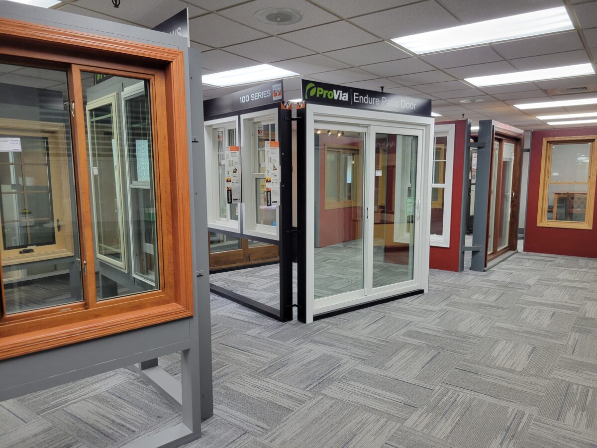 Interior view of Minnesota Exteriors showroom with various home remodeling displays.