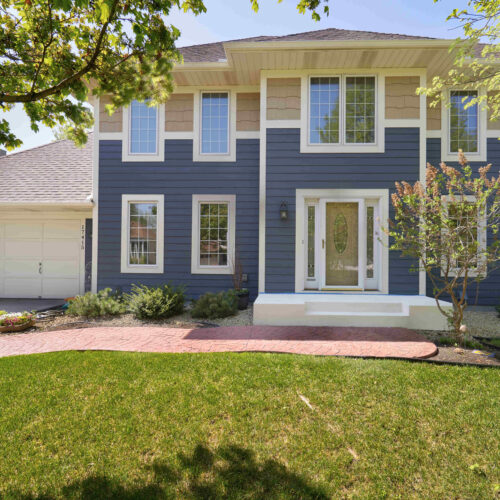 LP SmartSiding installed in blue on a two story home