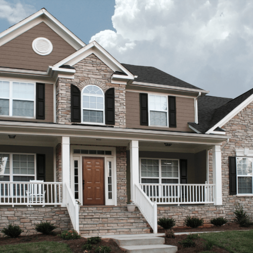 Residential home featuring durable manufactured stone siding.