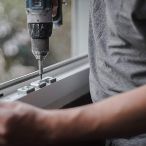 A contractor installing a bay window in a home.